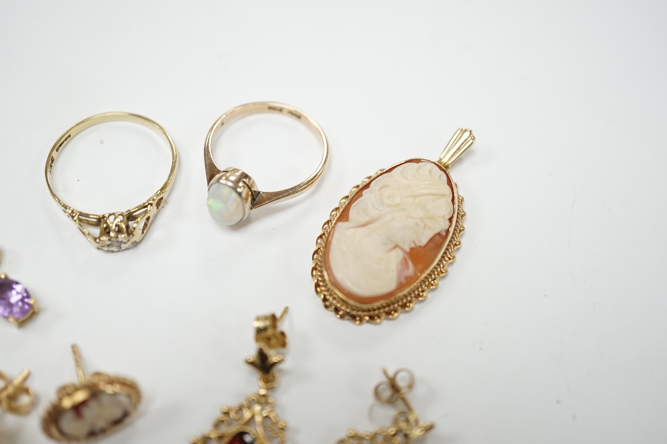 Two 9ct and gem set rings, including diamond chip and white opal, a 9ct and amethyst set pendant necklace, pair of 9ct gold and garnet earrings, a 9ct mounted cameo shell brooch and pair of matching earrings, gross weigh